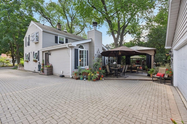 1427 S 5th St, Saint Charles, IL 60174 - view of home's exterior featuring a gazebo, a chimney, and a patio