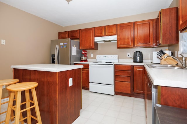 7 Crystal Ct, Bloomington, IL 61704 - kitchen featuring stainless steel appliances, under cabinet range hood, light countertops, a breakfast bar, and a kitchen island