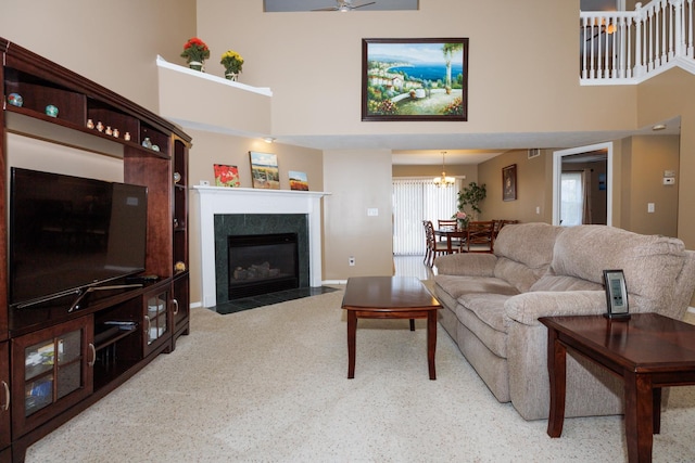 7 Crystal Ct, Bloomington, IL 61704 - carpeted living area featuring a high ceiling, a fireplace, and a chandelier