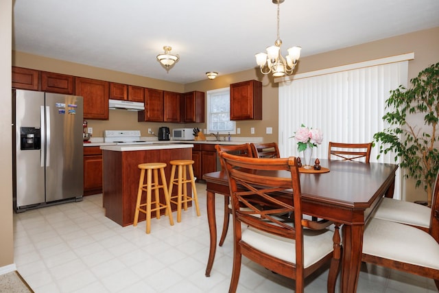 7 Crystal Ct, Bloomington, IL 61704 - kitchen featuring white appliances, under cabinet range hood, light countertops, a chandelier, and a kitchen island