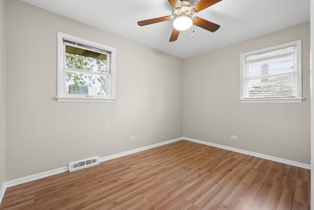 7707 S Oketo Ave, Bridgeview, IL 60455 - empty room featuring light wood finished floors and ceiling fan