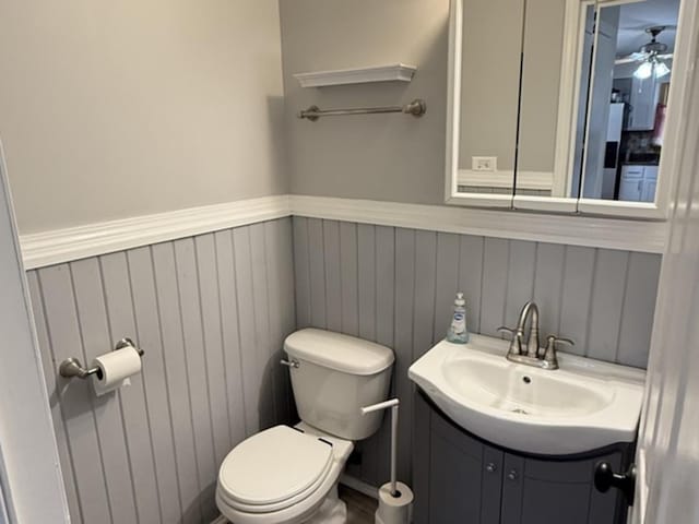 7707 S Oketo Ave, Bridgeview, IL 60455 - bathroom with vanity, a wainscoted wall, and a ceiling fan