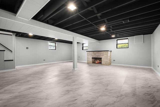 7707 S Oketo Ave, Bridgeview, IL 60455 - below grade area with plenty of natural light, a warm lit fireplace, light marble finish flooring, and wood walls
