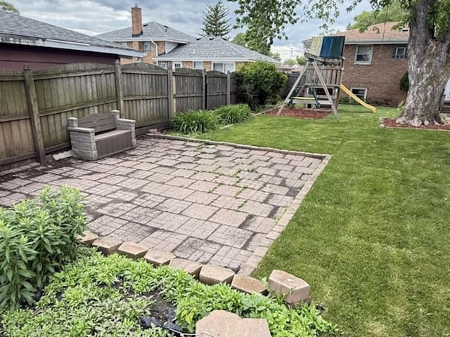 7707 S Oketo Ave, Bridgeview, IL 60455 - fenced backyard featuring a playground and a patio