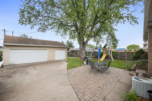 7707 S Oketo Ave, Bridgeview, IL 60455 - view of patio featuring a playground, a detached garage, an outbuilding, and a grill