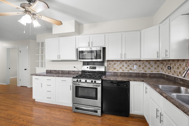 7707 S Oketo Ave, Bridgeview, IL 60455 - kitchen featuring stainless steel appliances, white cabinets, dark countertops, decorative backsplash, and a ceiling fan