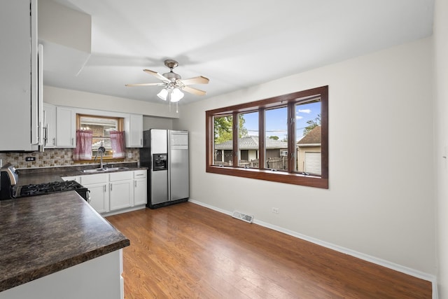 7707 S Oketo Ave, Bridgeview, IL 60455 - kitchen with stainless steel appliances, dark countertops, decorative backsplash, ceiling fan, and plenty of natural light