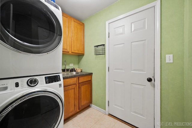 529 Hammer Ln, North Aurora, IL 60542 - washroom featuring stacked washer / drying machine, cabinet space, and light tile patterned floors