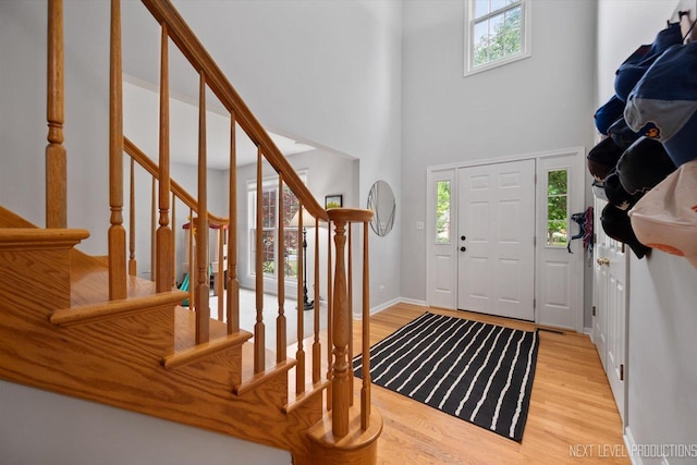 529 Hammer Ln, North Aurora, IL 60542 - entrance foyer featuring plenty of natural light, light wood-style flooring, stairway, and a towering ceiling
