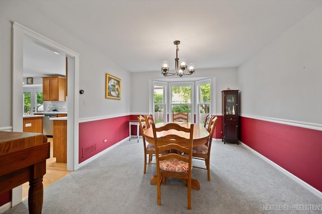 529 Hammer Ln, North Aurora, IL 60542 - dining room featuring a chandelier and light carpet