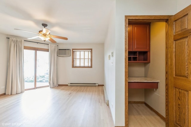 4301 W Shamrock Ln Unit 1C, Mchenry, IL 60050 - empty room featuring a baseboard radiator, light wood-type flooring, a wall unit AC, and a ceiling fan