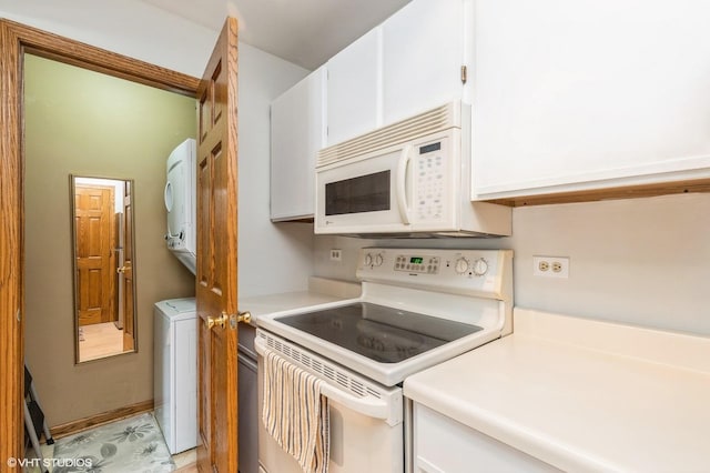 4301 W Shamrock Ln Unit 1C, Mchenry, IL 60050 - kitchen featuring white appliances, stacked washing machine and dryer, white cabinetry, and light countertops