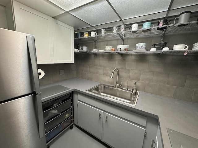 200 Deborah Ln Unit 13C, Wheeling, IL 60090 - kitchen with freestanding refrigerator, backsplash, light countertops, open shelves, and white cabinets