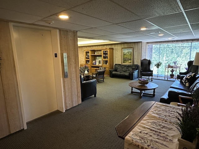 200 Deborah Ln Unit 13C, Wheeling, IL 60090 - carpeted living area with a drop ceiling, wood walls, and elevator