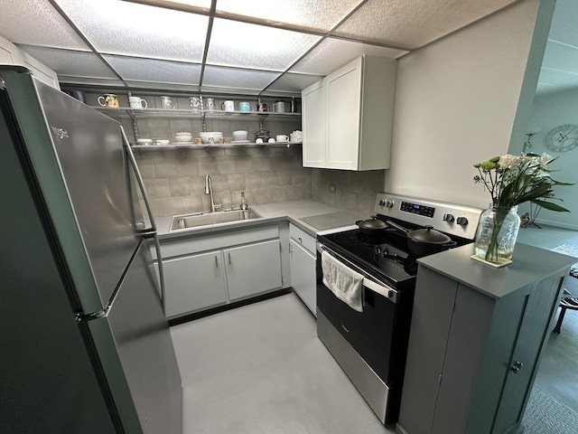 200 Deborah Ln Unit 13C, Wheeling, IL 60090 - kitchen with stainless steel appliances, decorative backsplash, white cabinetry, a drop ceiling, and light countertops