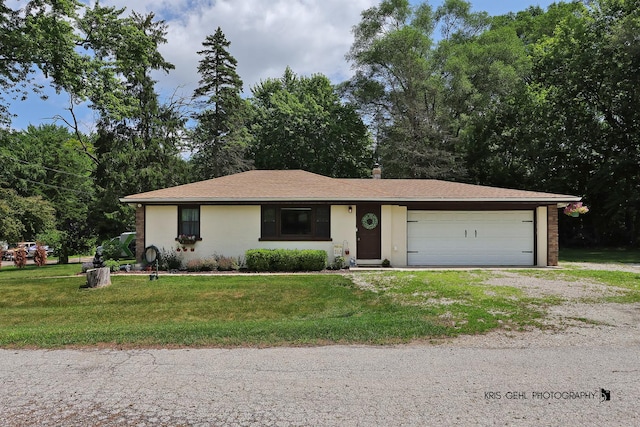 1601 Bolling Ave, Johnsburg, IL 60051 - single story home with dirt driveway, a front yard, a garage, and stucco siding