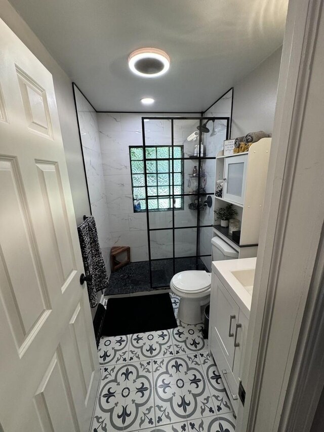 1601 Bolling Ave, Johnsburg, IL 60051 - bathroom featuring a tile shower, vanity, and tile patterned floors