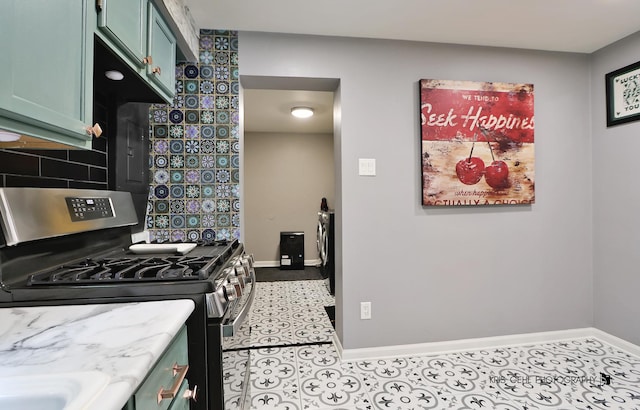1601 Bolling Ave, Johnsburg, IL 60051 - kitchen with stainless steel range with gas cooktop, green cabinetry, tasteful backsplash, and tile patterned flooring