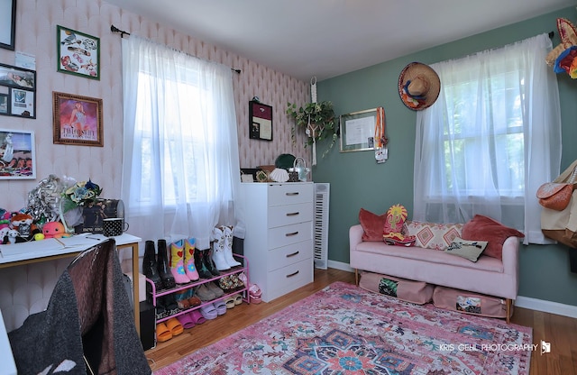 1601 Bolling Ave, Johnsburg, IL 60051 - bedroom featuring wallpapered walls, an accent wall, and wood finished floors