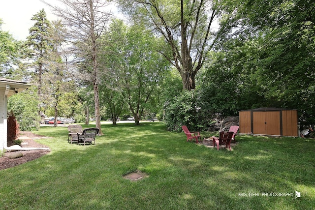 1601 Bolling Ave, Johnsburg, IL 60051 - view of grassy yard with a shed and an outdoor fire pit