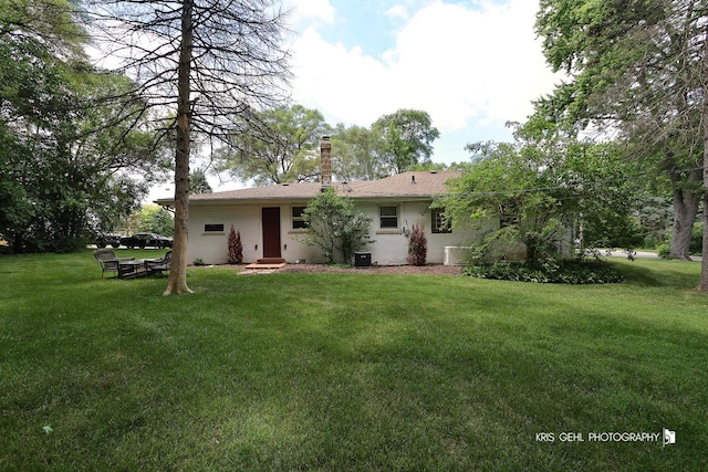 1601 Bolling Ave, Johnsburg, IL 60051 - back of property with a lawn and a chimney