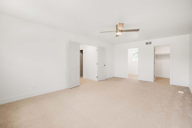 716 Somerset Ln, Darien, IL 60561 - unfurnished bedroom with light carpet, a walk in closet, a closet, and a ceiling fan