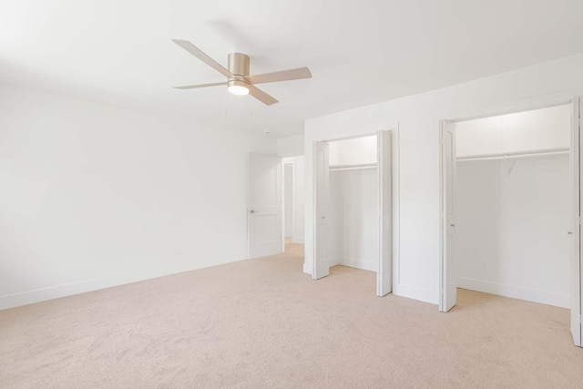 716 Somerset Ln, Darien, IL 60561 - unfurnished bedroom featuring two closets, light carpet, and a ceiling fan