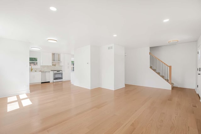716 Somerset Ln, Darien, IL 60561 - unfurnished living room with light wood-style floors, stairway, and recessed lighting