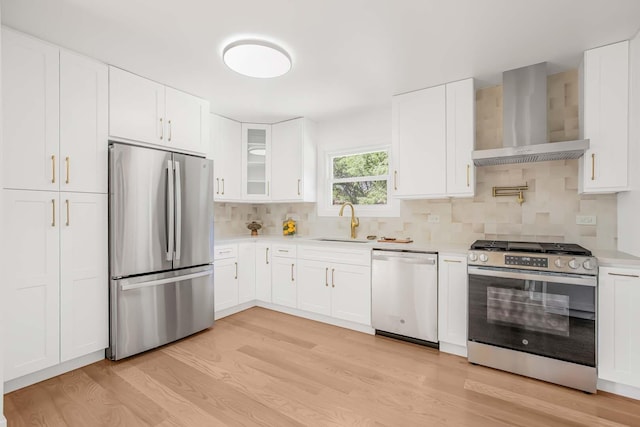 716 Somerset Ln, Darien, IL 60561 - kitchen with appliances with stainless steel finishes, wall chimney range hood, light wood-type flooring, light countertops, and decorative backsplash