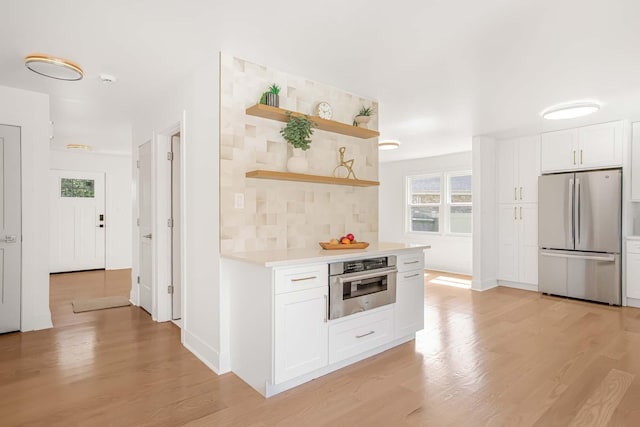 716 Somerset Ln, Darien, IL 60561 - kitchen featuring appliances with stainless steel finishes, light countertops, open shelves, light wood-type flooring, and white cabinets