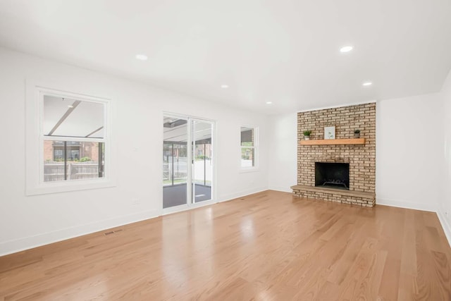 716 Somerset Ln, Darien, IL 60561 - unfurnished living room featuring healthy amount of natural light, wood finished floors, a brick fireplace, and recessed lighting