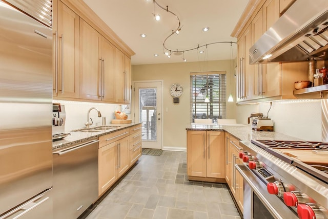 917 W Gunnison St Unit 1W, Chicago, IL 60640 - kitchen with high quality appliances, under cabinet range hood, light brown cabinets, a peninsula, and light stone counters
