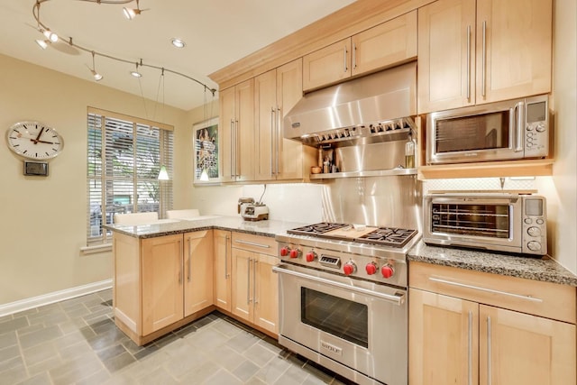 917 W Gunnison St Unit 1W, Chicago, IL 60640 - kitchen with stainless steel appliances, light brown cabinets, under cabinet range hood, a peninsula, and light stone counters