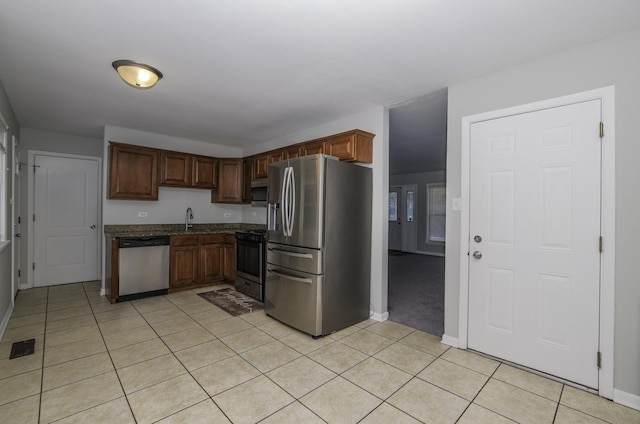 17801 Dogwood Ln, Hazel Crest, IL 60429 - kitchen featuring appliances with stainless steel finishes, light tile patterned flooring, and dark stone countertops