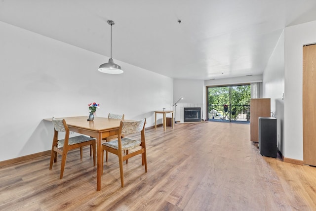 671 Hapsfield Ln Unit 105, Buffalo Grove, IL 60089 - dining space with light wood finished floors and a tile fireplace