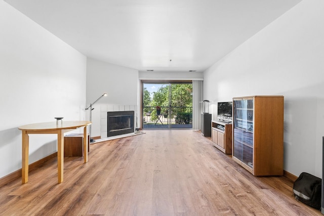 671 Hapsfield Ln Unit 105, Buffalo Grove, IL 60089 - unfurnished living room featuring light wood finished floors and a tile fireplace