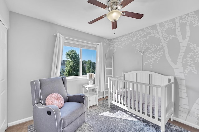 39371 Crofton Ln, Beach Park, IL 60083 - bedroom featuring a crib, ceiling fan, and carpet flooring