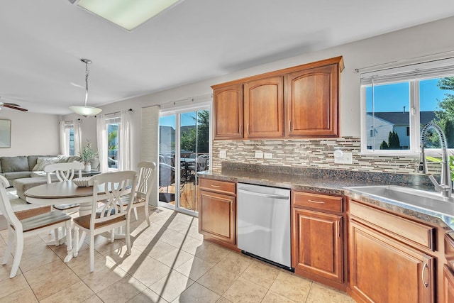 39371 Crofton Ln, Beach Park, IL 60083 - kitchen with stainless steel dishwasher, dark countertops, decorative backsplash, brown cabinetry, and open floor plan