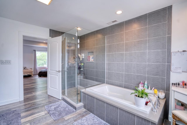 281 Fox Chase Dr N, Oswego, IL 60543 - ensuite bathroom with wood finished floors, a bath, a stall shower, and recessed lighting