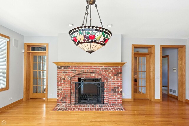 4829 Linscott Ave, Downers Grove, IL 60515 - unfurnished living room with wood finished floors and a brick fireplace