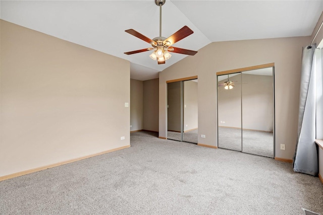 2442 Oneida Ln, Naperville, IL 60563 - unfurnished bedroom with two closets, carpet flooring, vaulted ceiling, and a ceiling fan