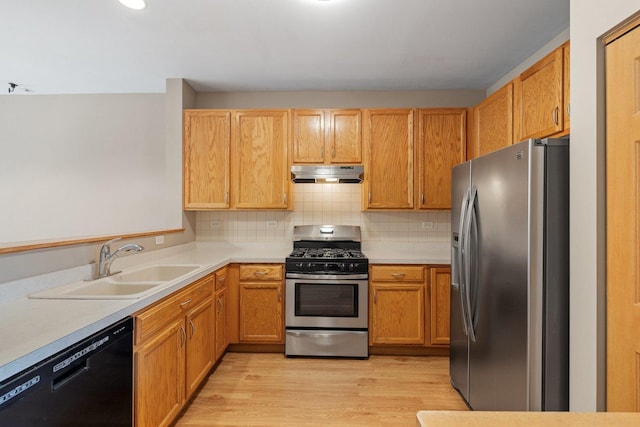 2442 Oneida Ln, Naperville, IL 60563 - kitchen featuring stainless steel appliances, under cabinet range hood, light wood-style floors, light countertops, and decorative backsplash