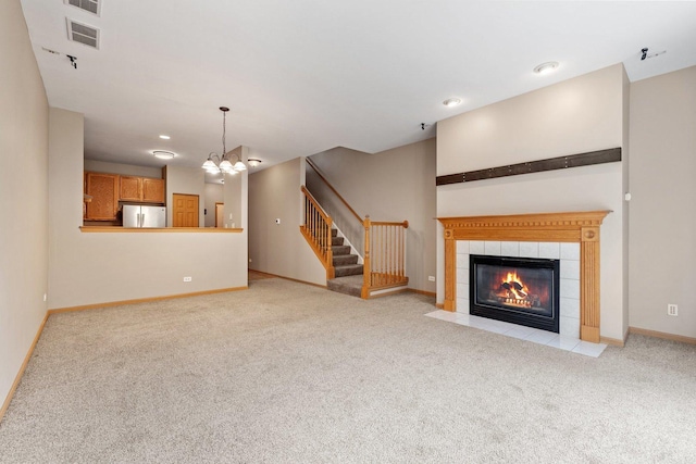 2442 Oneida Ln, Naperville, IL 60563 - unfurnished living room featuring carpet, a chandelier, a tiled fireplace, stairway, and recessed lighting