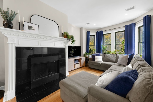 2636 N Fairfield Ave Unit 2N, Chicago, IL 60647 - living room with a tiled fireplace, light wood-type flooring, and recessed lighting