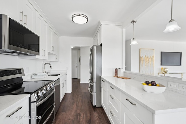 5445 N Sheridan Rd Unit 1515, Chicago, IL 60640 - kitchen featuring stainless steel appliances, white cabinetry, light stone countertops, and a peninsula