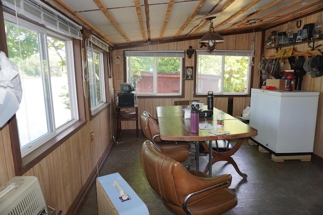 7084 N River Rd, Byron, IL 61010 - dining room with wooden walls, plenty of natural light, and lofted ceiling