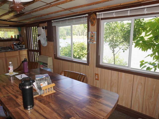 7084 N River Rd, Byron, IL 61010 - dining area with healthy amount of natural light and wooden walls