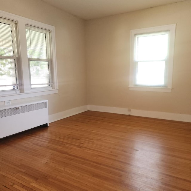 1223 Putnam St, Peru, IL 61354 - unfurnished room with radiator heating unit and wood finished floors