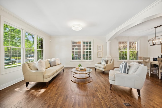 1318 Bennington Ct, Glenview, IL 60026 - living room featuring a chandelier, ornamental molding, wood finished floors, arched walkways, and ornate columns