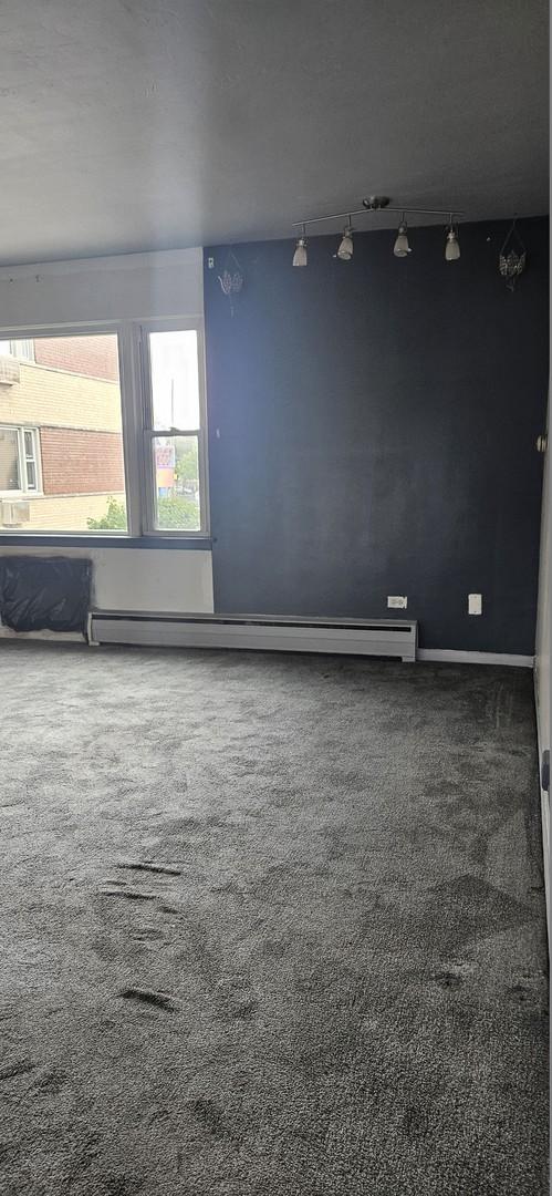 1541 Harlem Ave Unit 2S, Forest Park, IL 60130 - carpeted spare room with baseboard heating